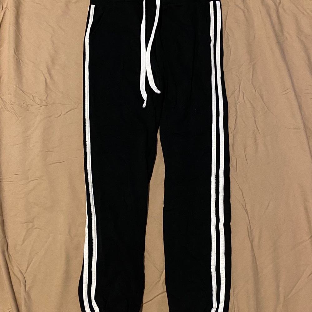 Black joggers with two white stripes